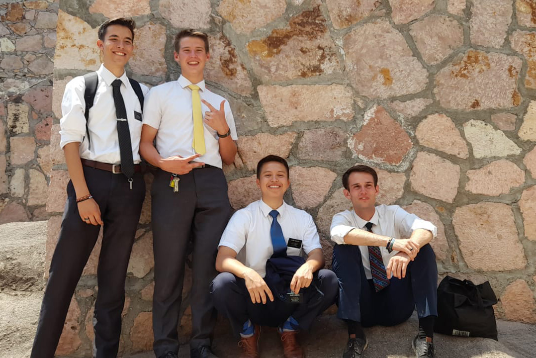 missionaries and a rock wall